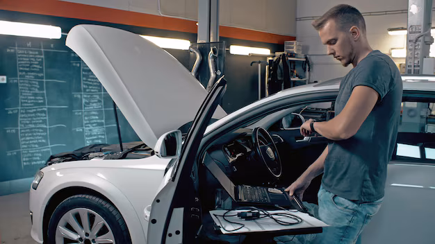 technician-worker-making-computer-diagnostics-of-a-car